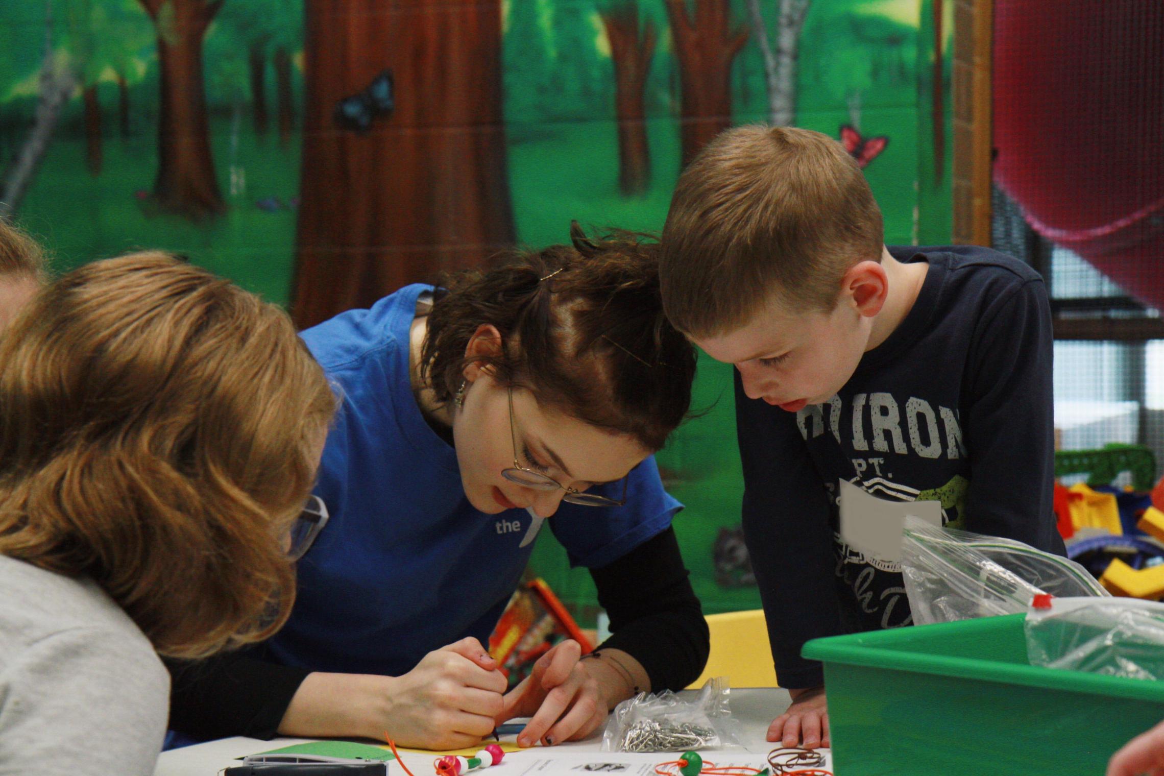 Y Staff working on an art project with two youth