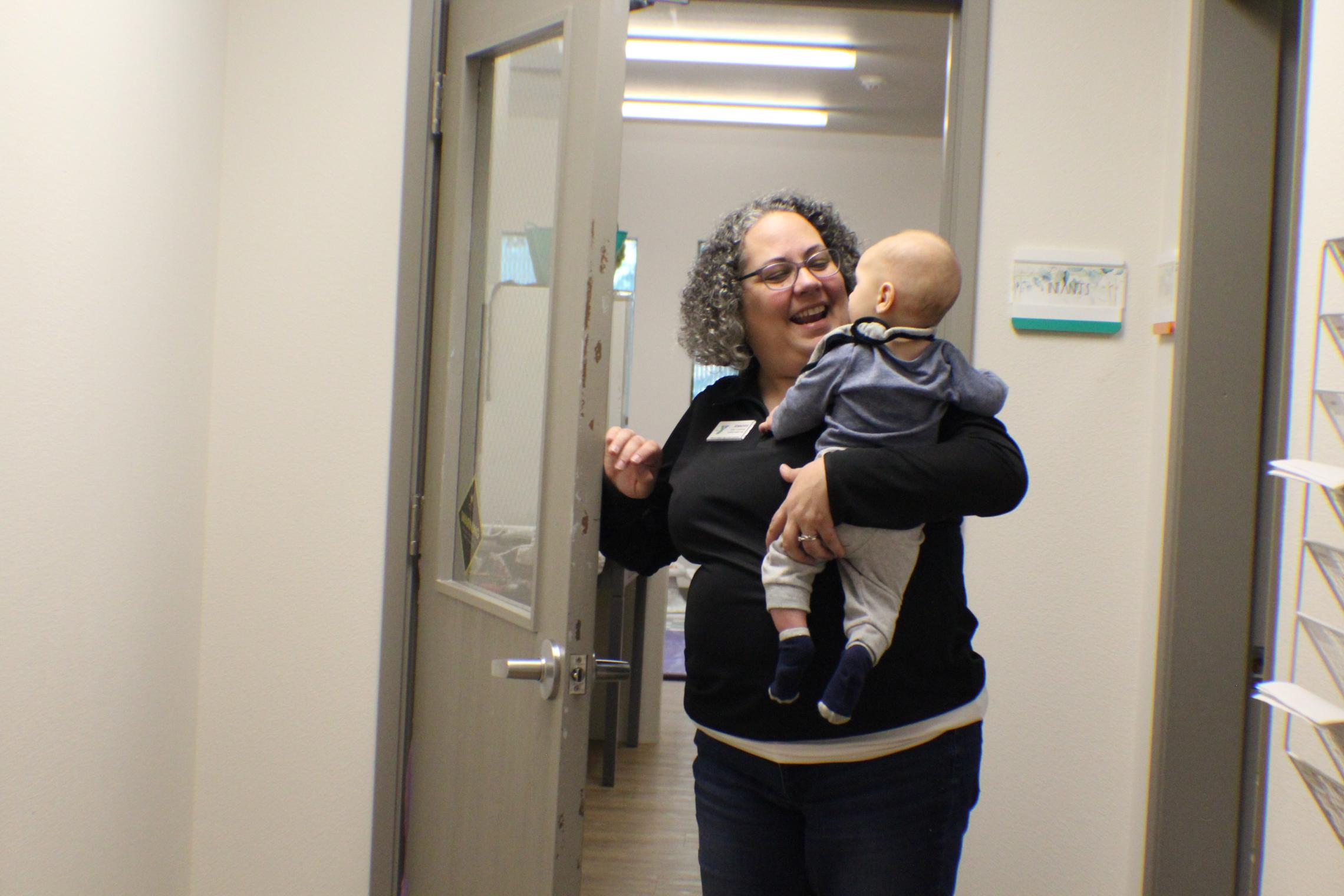 Center Director Jennifer Wroblos walking out a child to parents at the UP ELC  