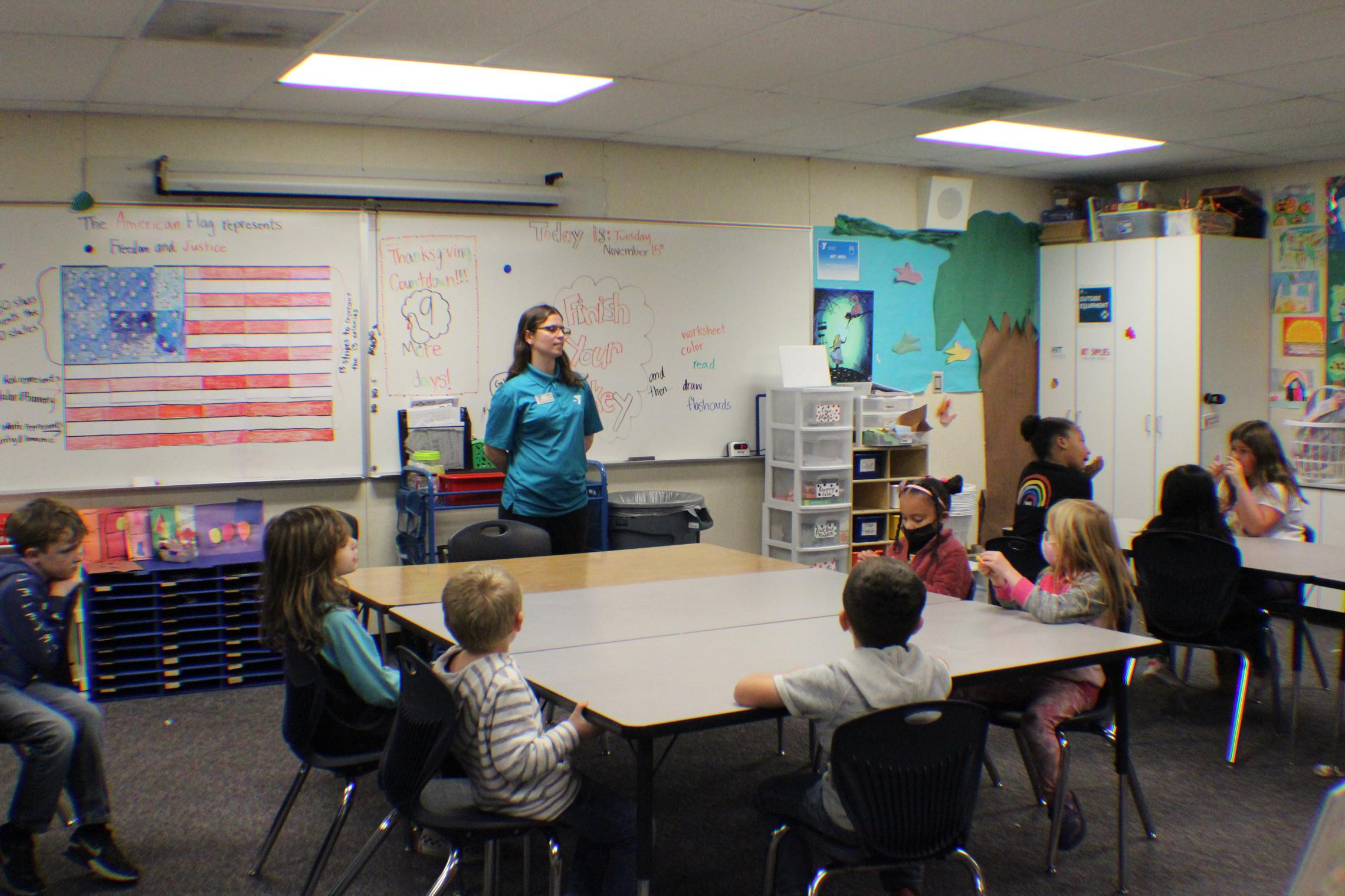 Site Director Ashely Nelson preparing the class for their snack time 