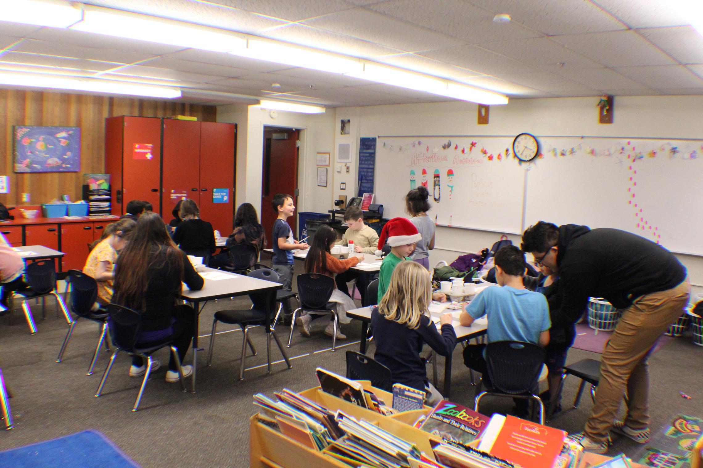 Riffle (left) and Chavez (right) working on art project with the children 