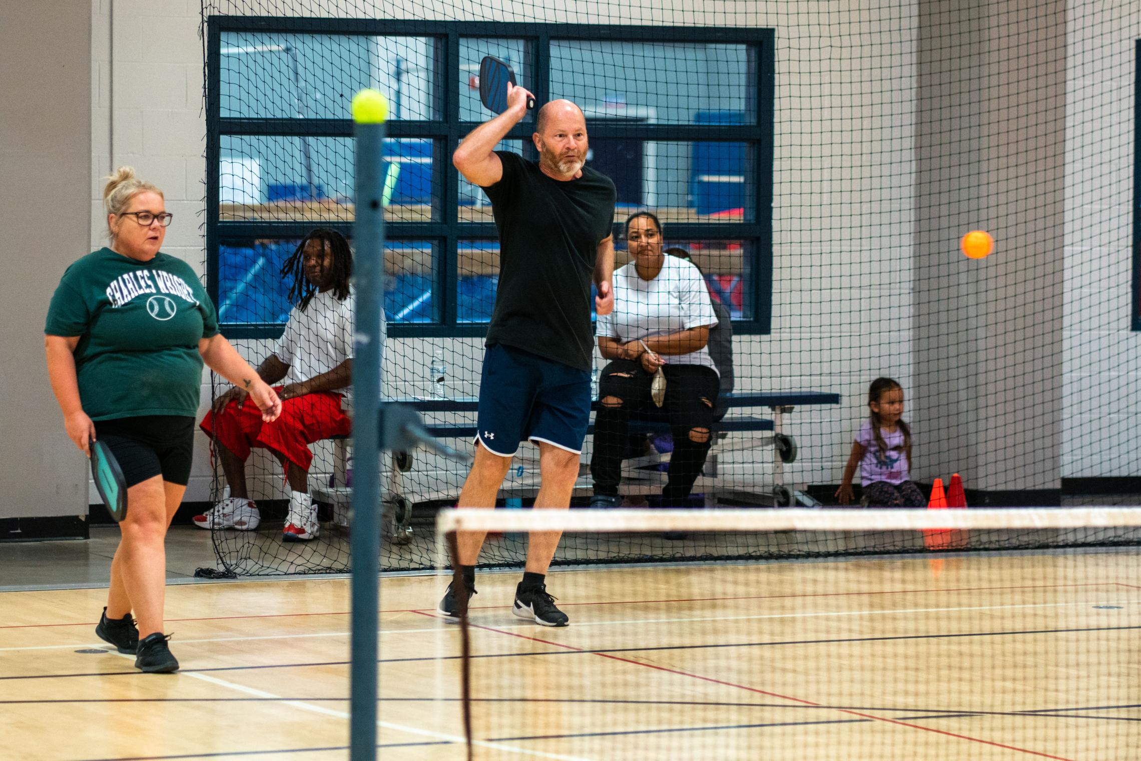 Action shot of pickleball team post swing