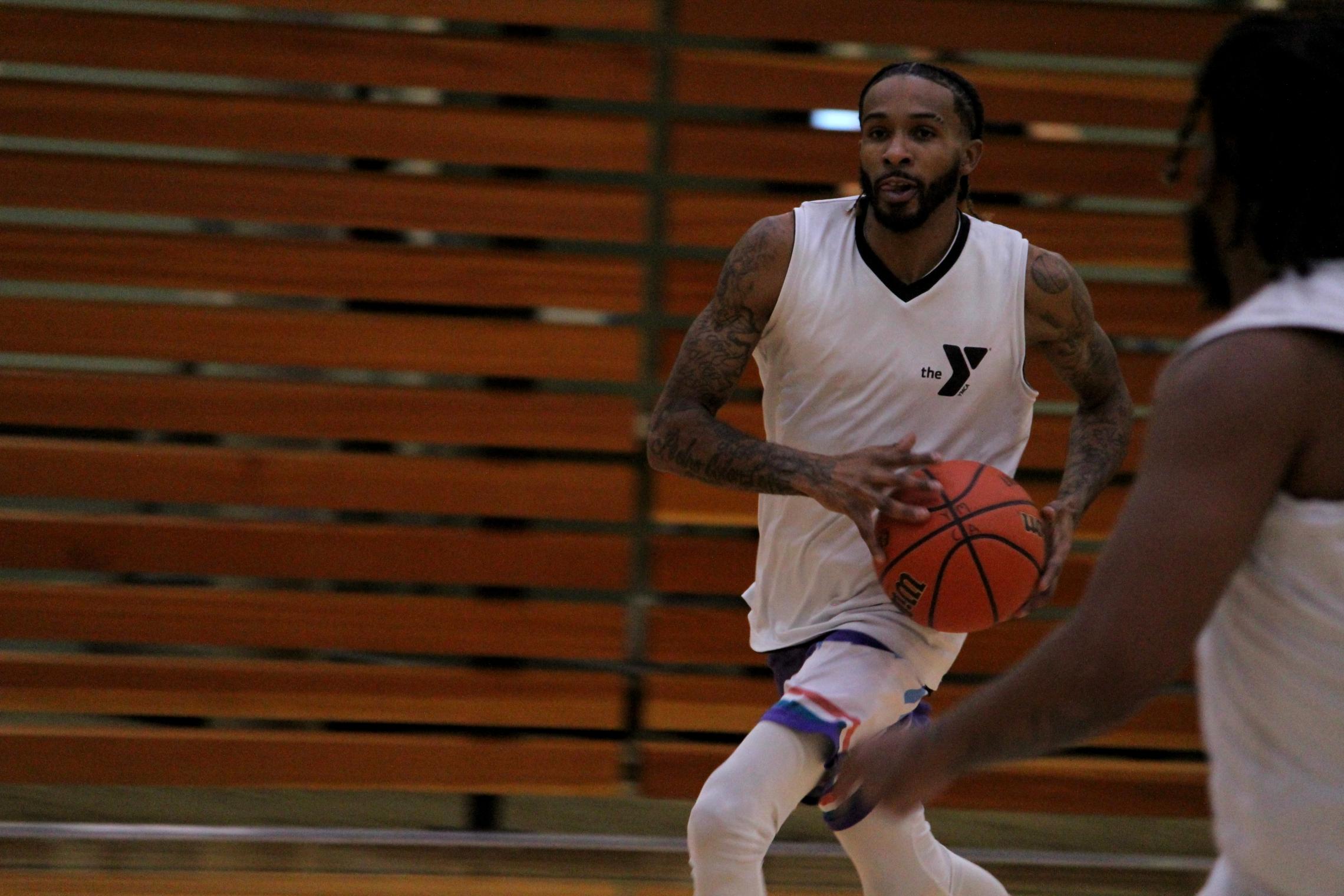 Adult basketball player drives the ball into the key