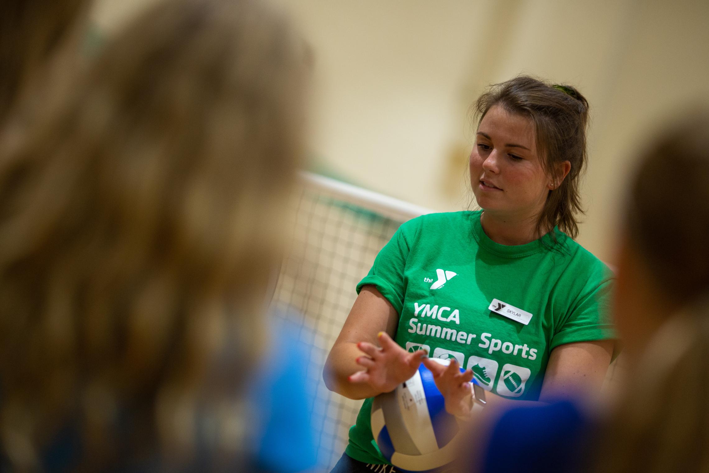 YMCA volleyball coach demonstrating good hand position