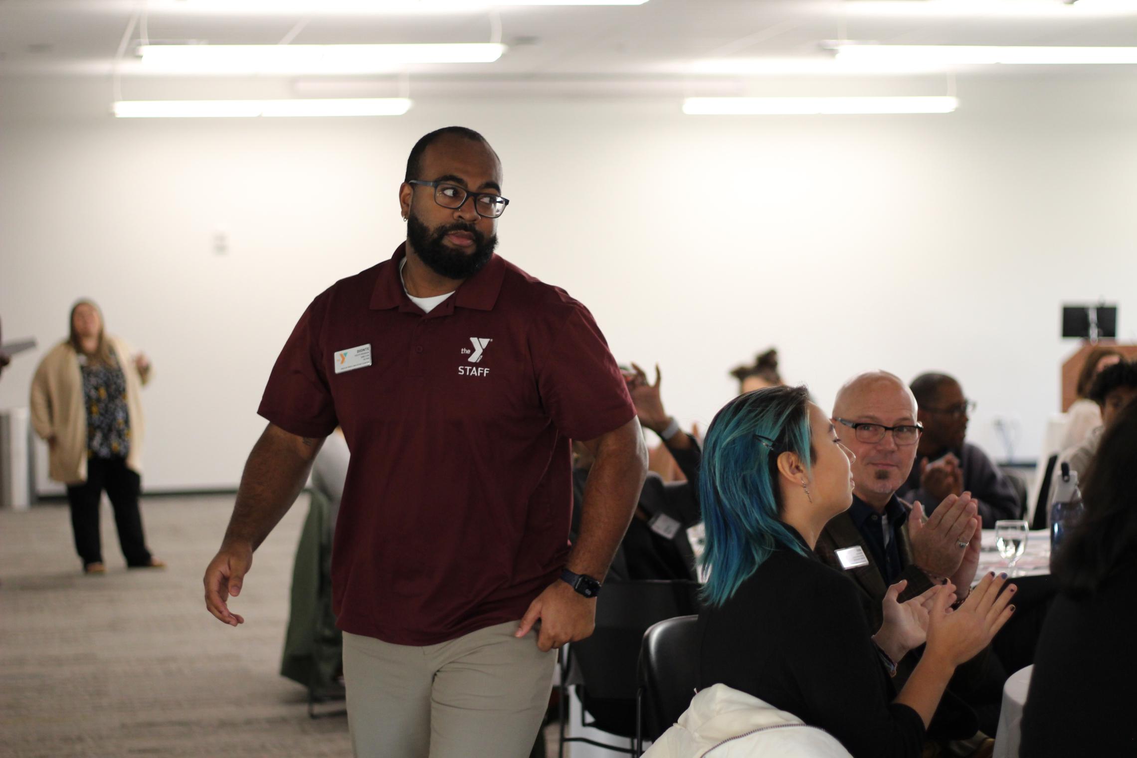 Site Director, Dionte Simon walking to stage to receive his award. 