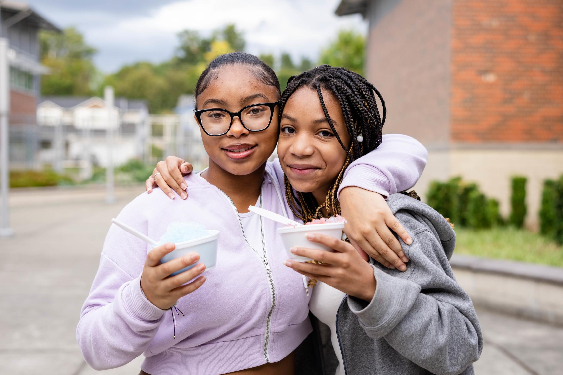 Teen friends pose with shaved ice at a Late Nite at the YMCA