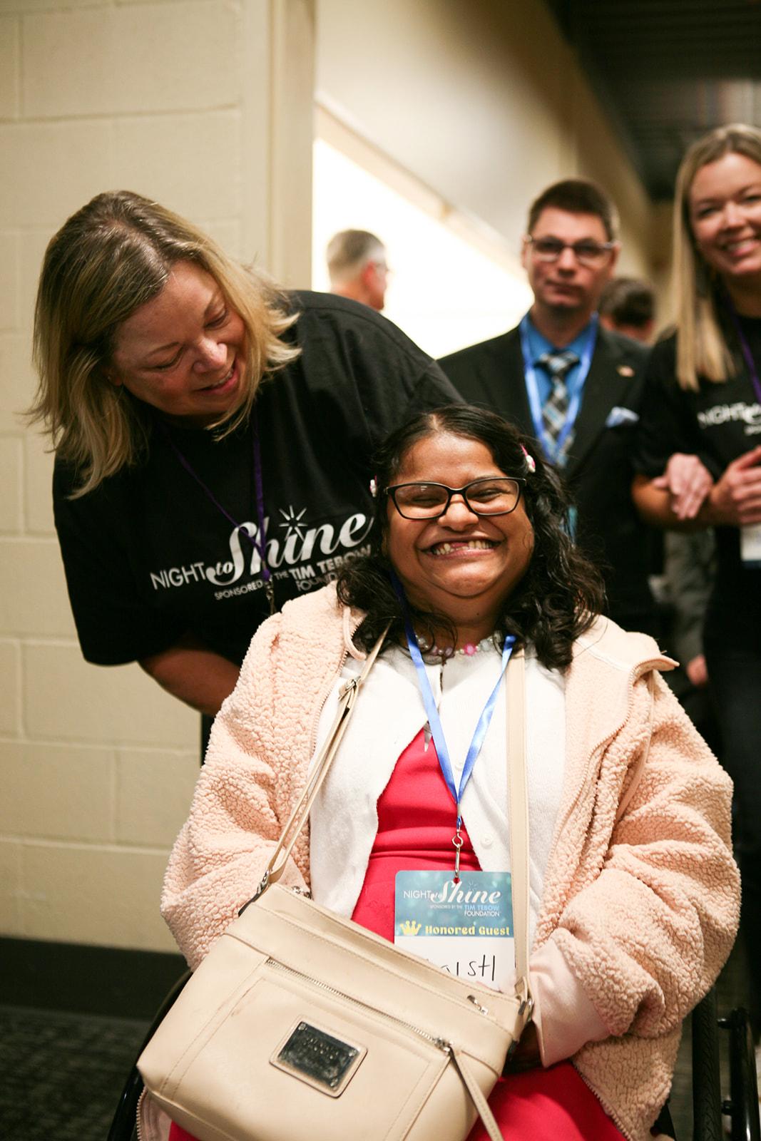 Night to Shine Volunteer and Guest posing together 