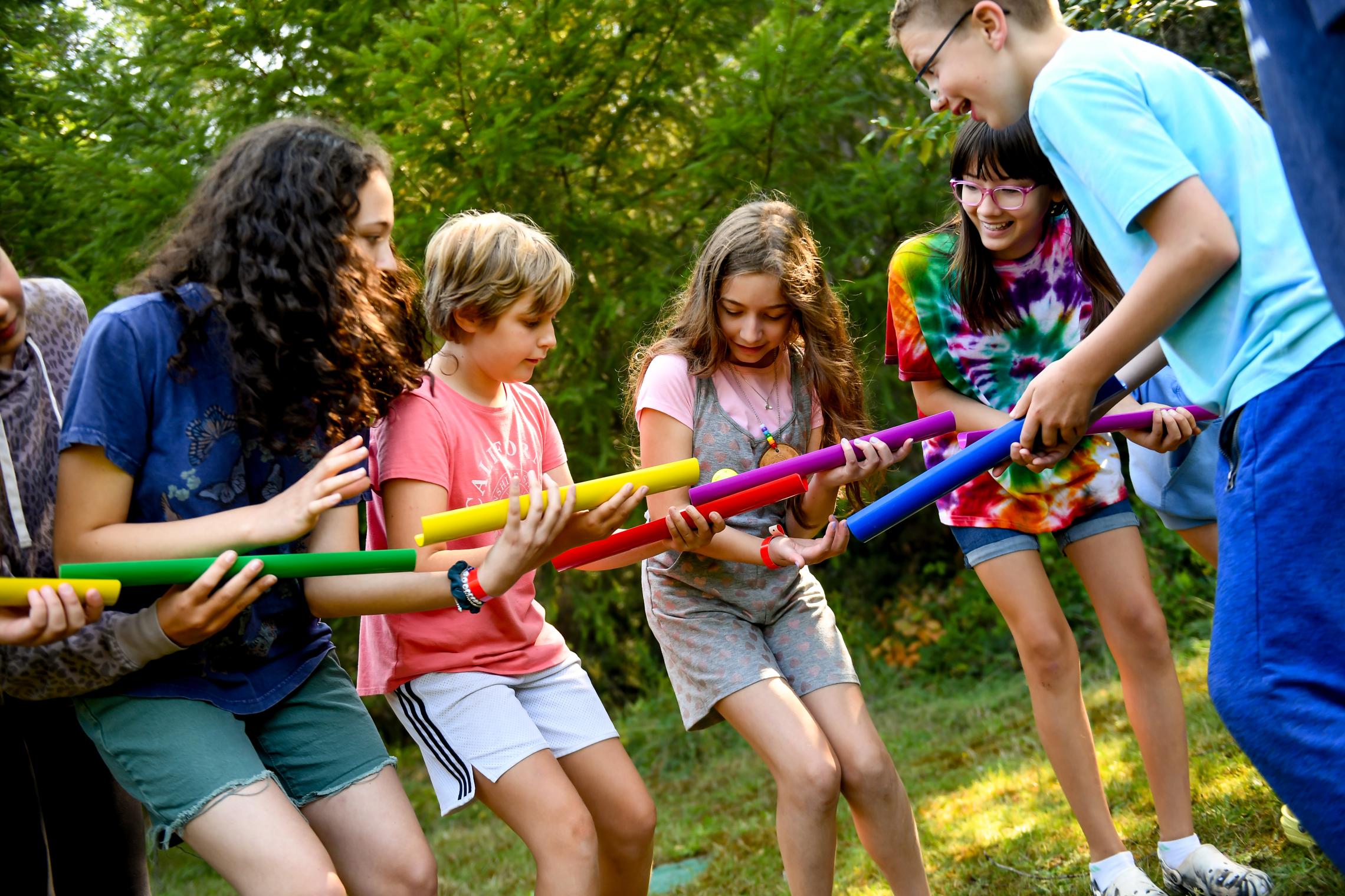 YMCA Camp Lake Helena participants engage in a team building exercise.