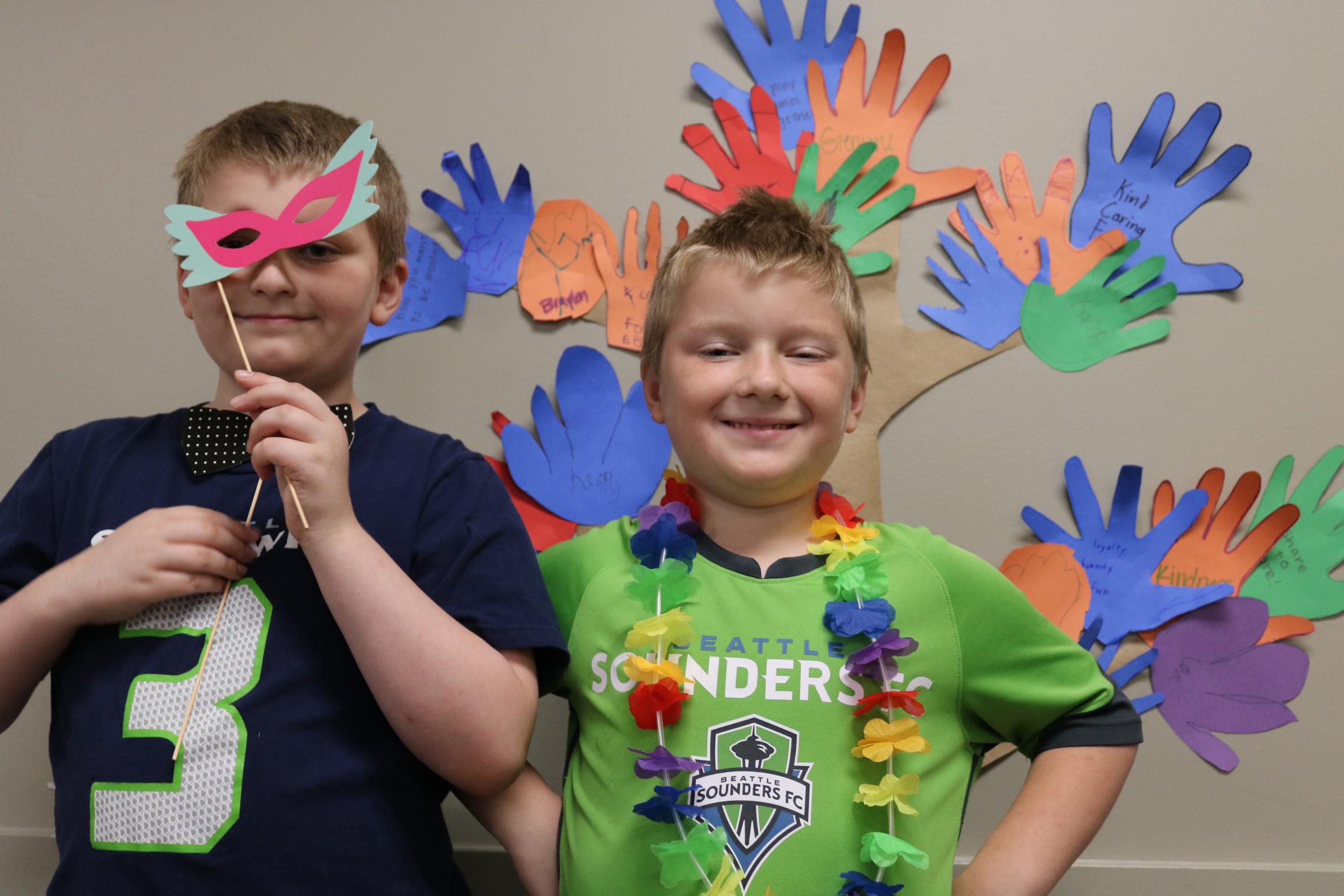 Summer camp participants pose with their newly made handicrafts at the YMCA
