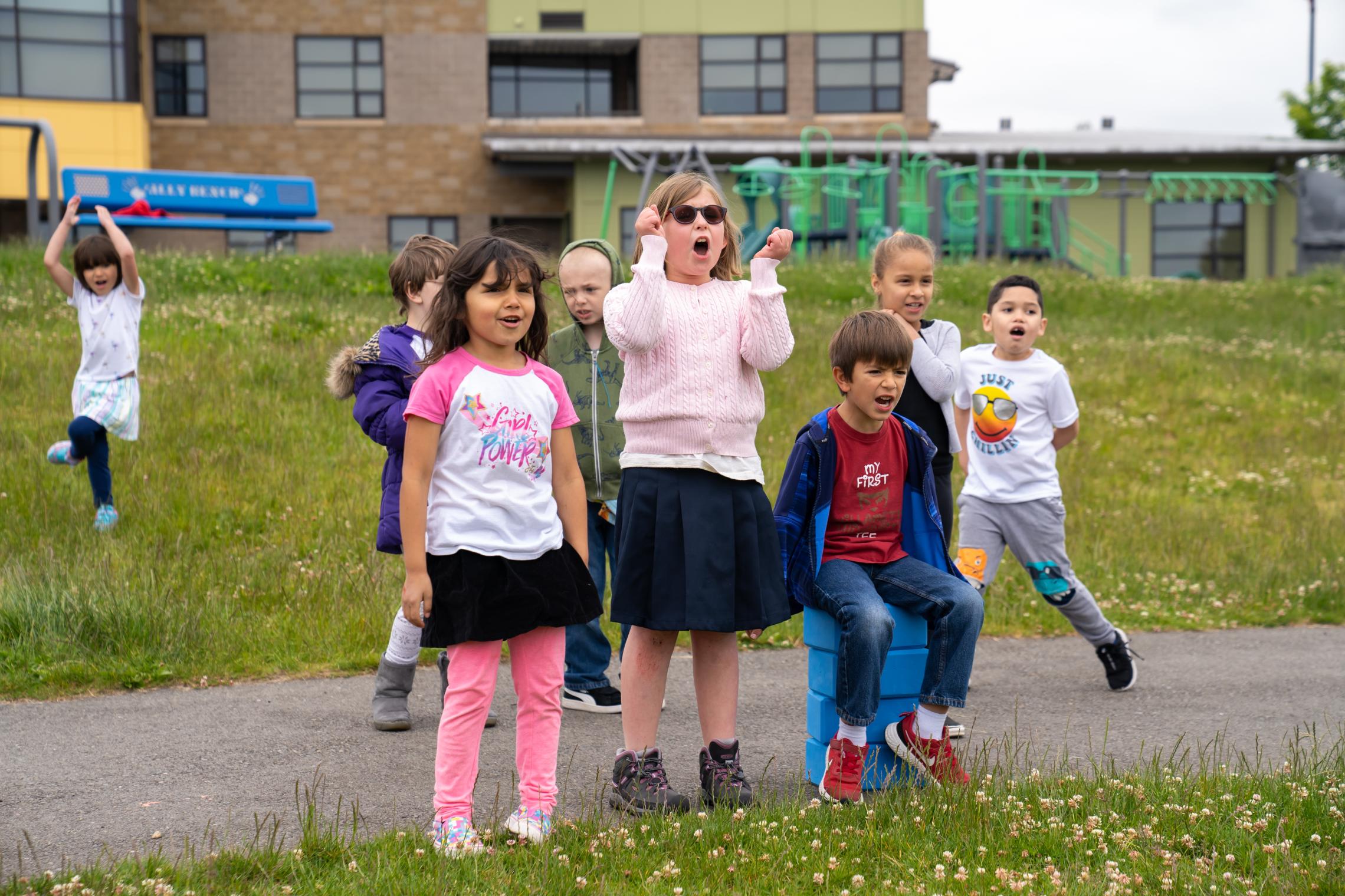 Child care kids spectate and cheer for a soccer game at the YMCA