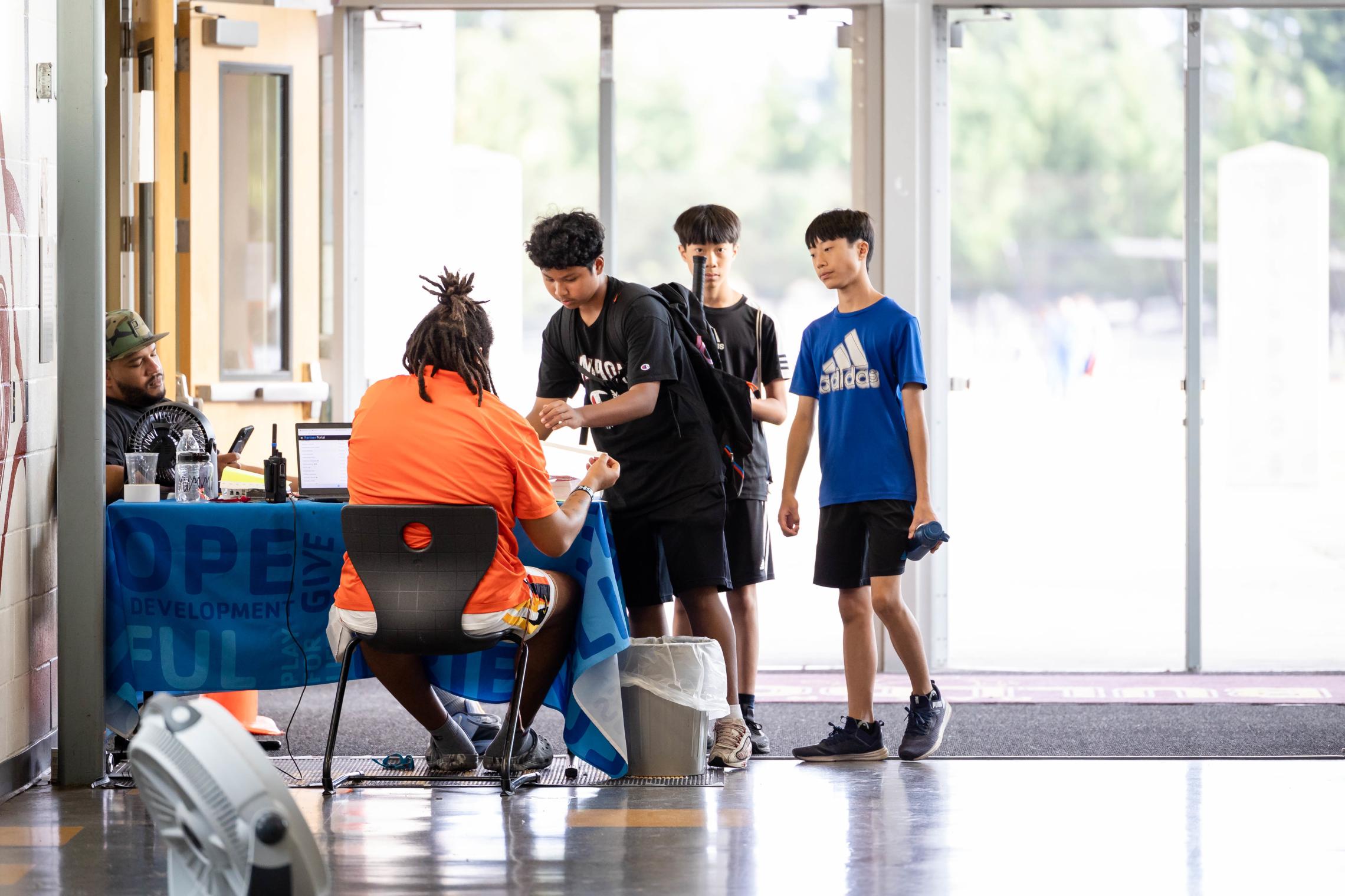 Teen Late Nite participants check in at the front desk at the YMCA