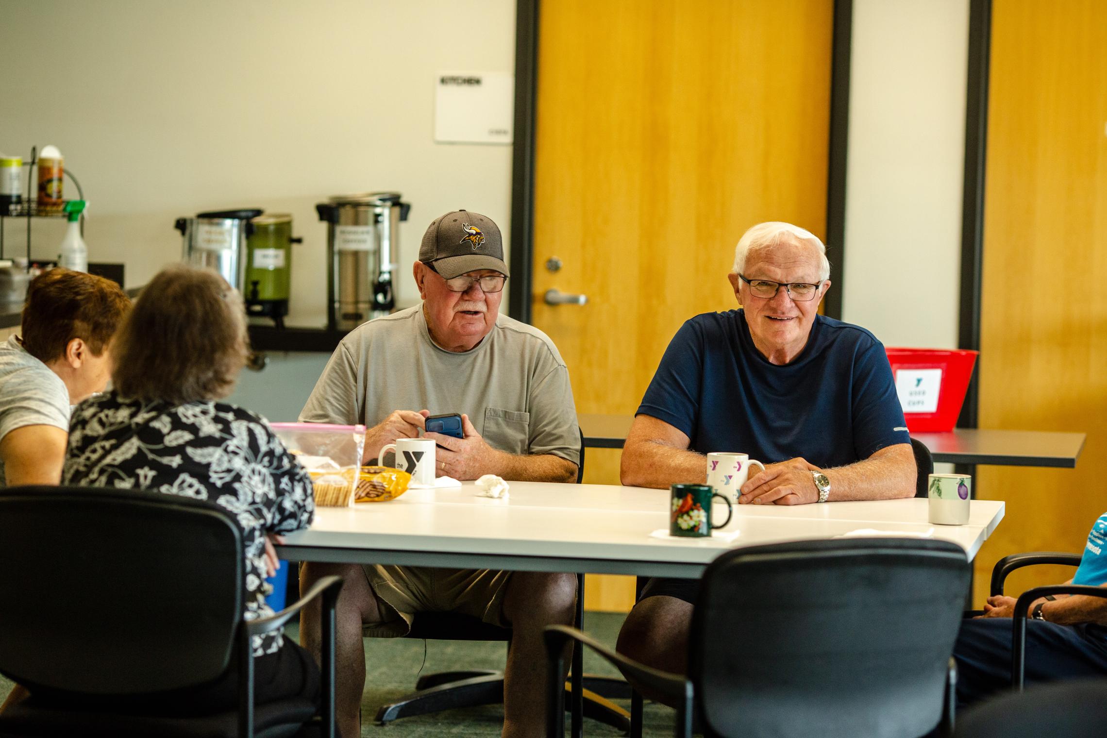 Coffee and cards participants chat over some fresh brewed coffee at the YMCA