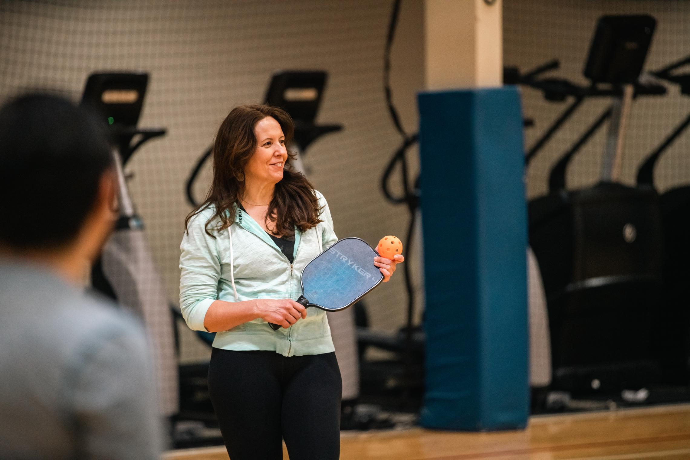 Pickleball instructor prepares to demonstrate serving techniques at the YMCA
