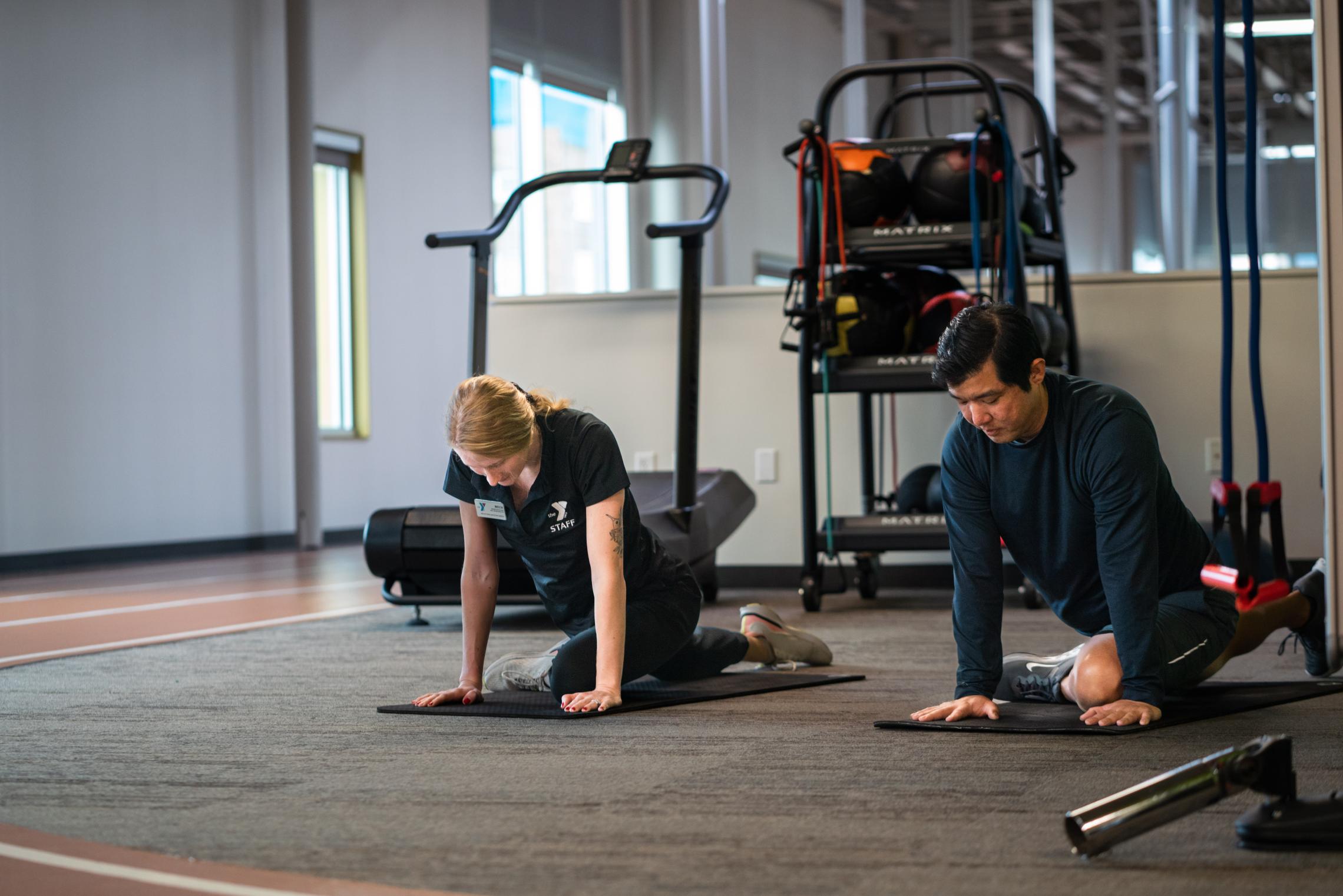 Kickstart participant follows along instructor for stretching