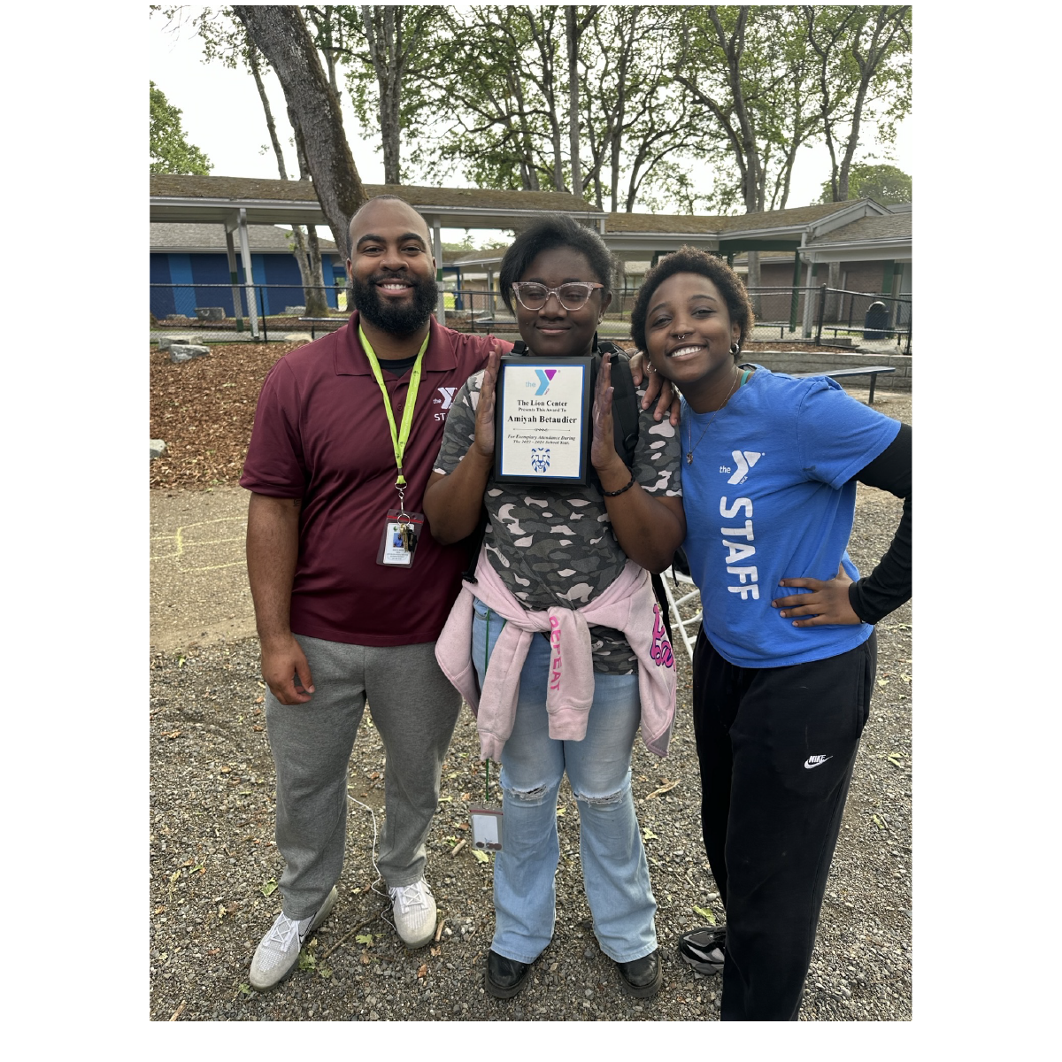 CLC Student poses with academic achievement award plaque received at the YMCA