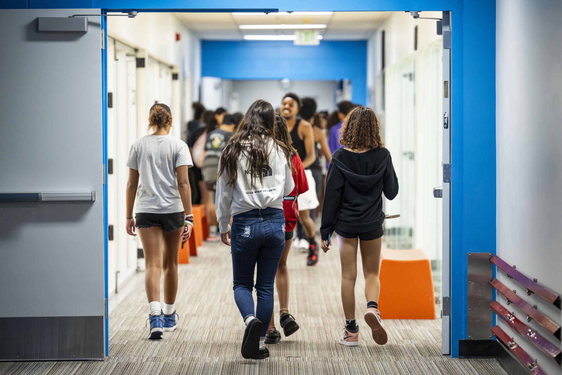 CCI students walking from the lobby into the main gym at the YMCA