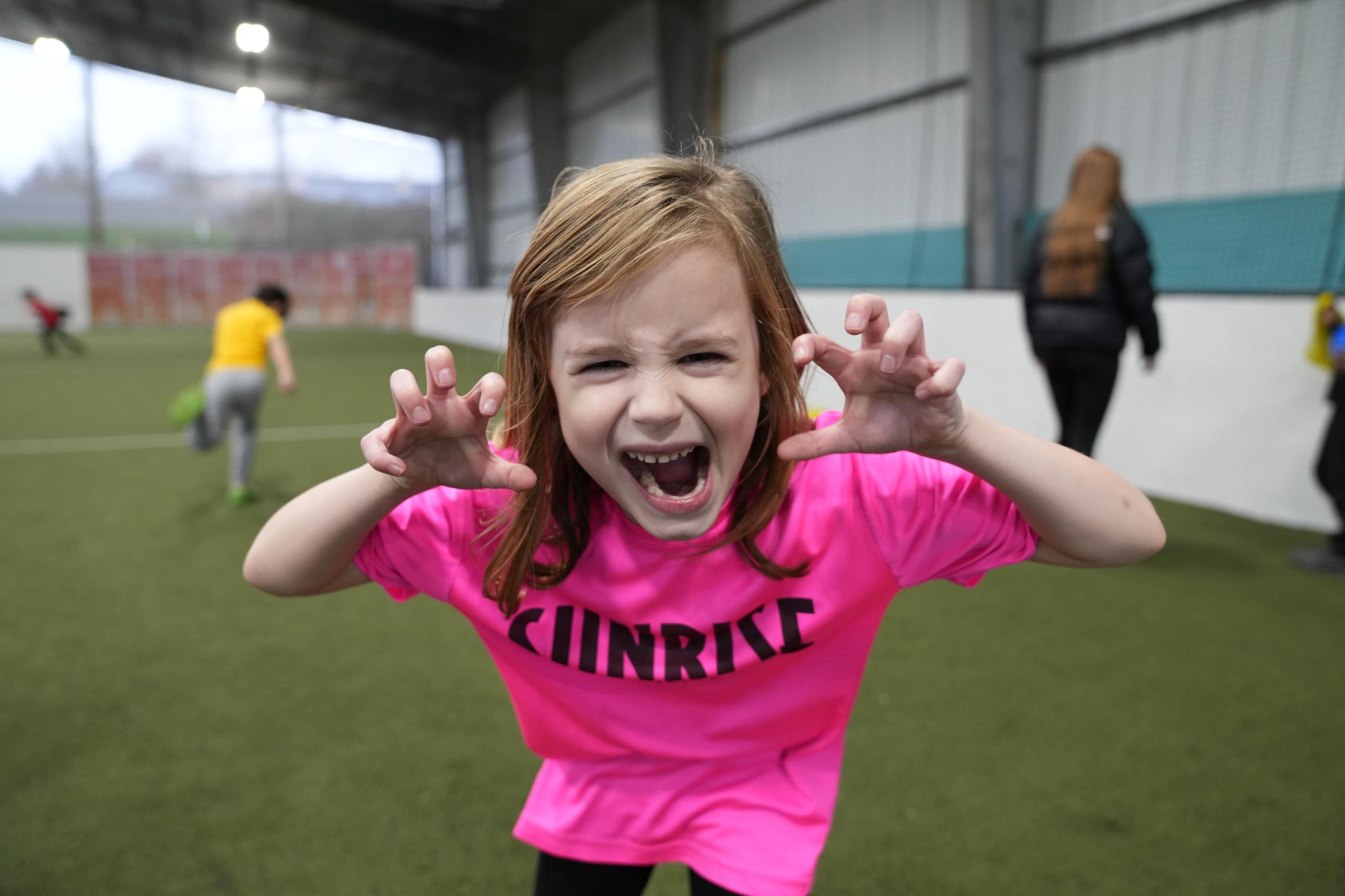 camp participant poses for a picture in the covered turf at the YMCA