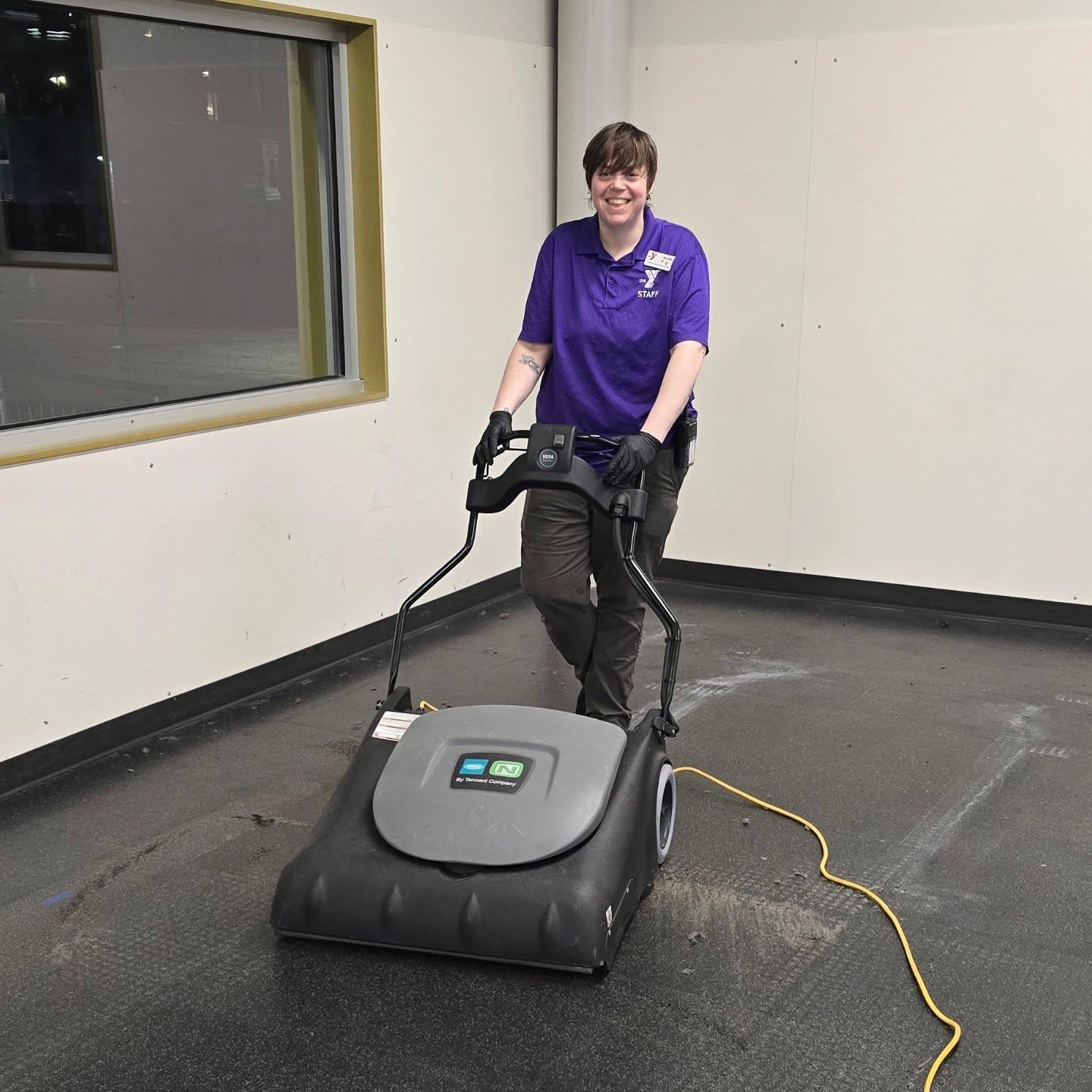 YMCA staff member vacuums their gym space during the remodel