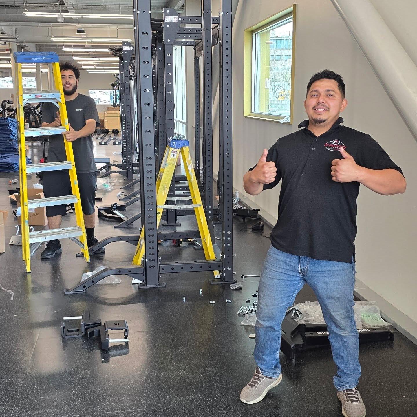A person gives a thumbs up during new machine installations at the YMCA
