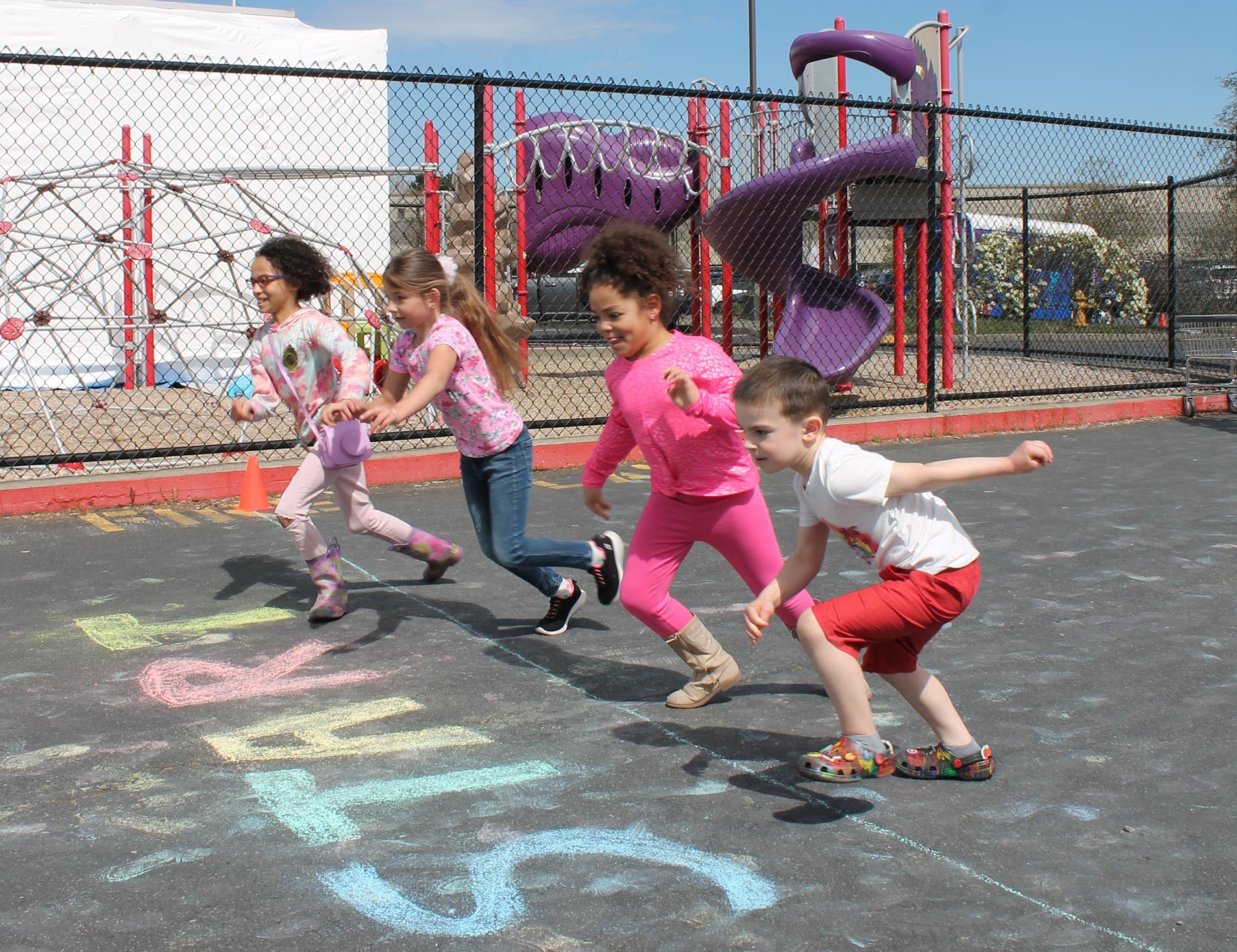 Action shot of Healthy Kids Day participants starting to run the fun run at the YMCA