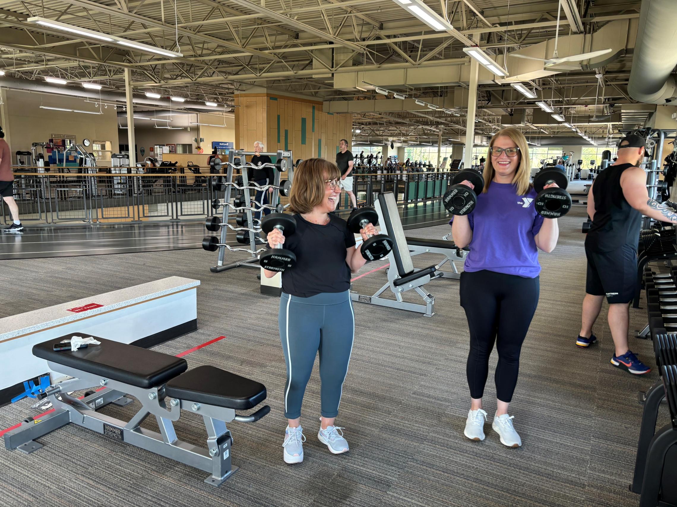 Jaclyn and Katie performing bicep curls