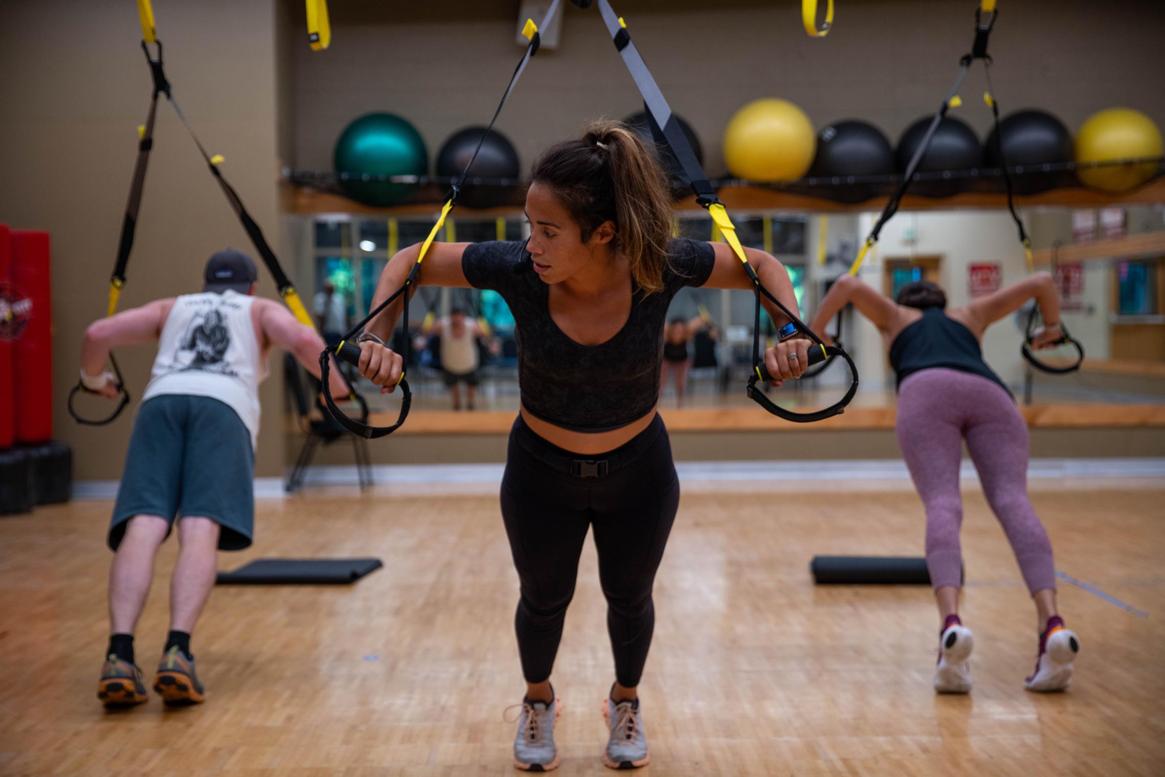 Action shot of a TRX instructor mid session at the YMCA