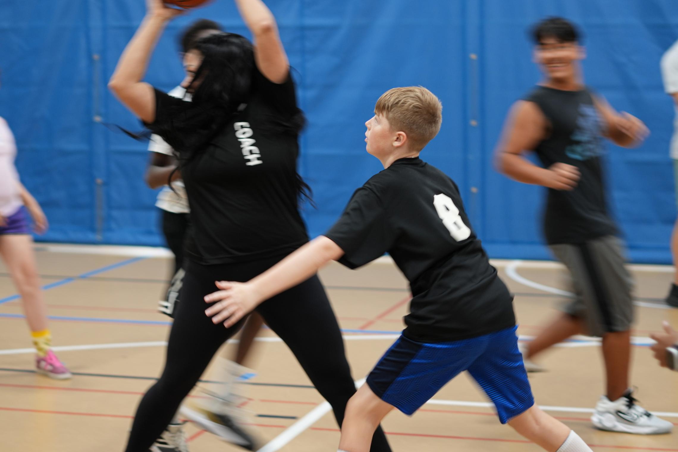Coach Ali passes the ball