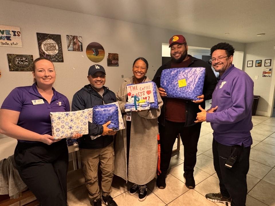 Y staff with Giving Tree gifts