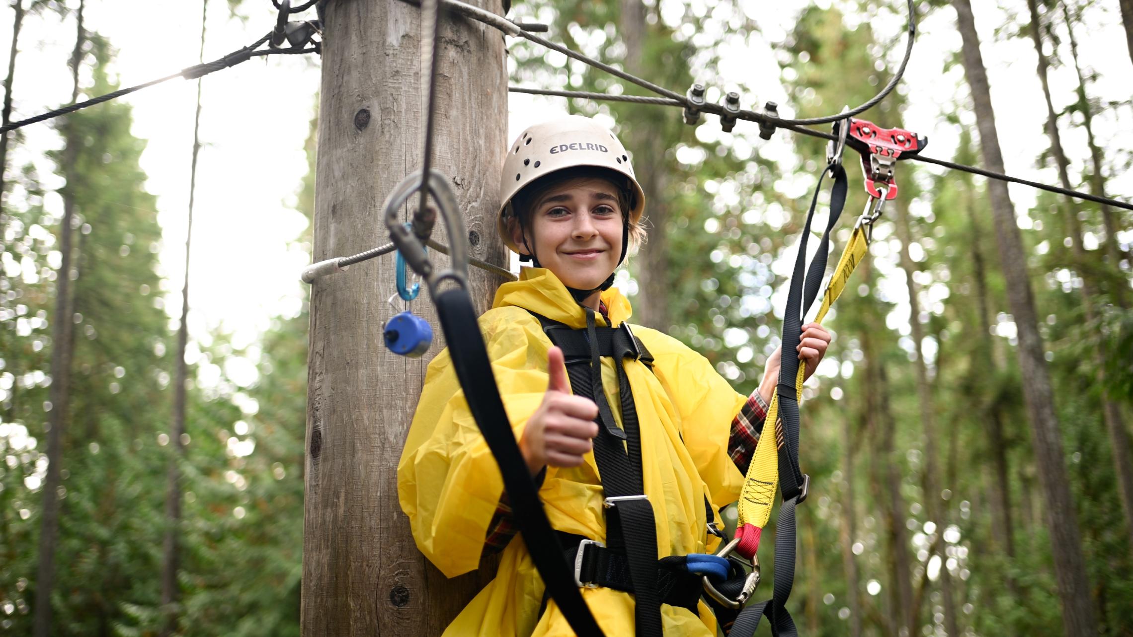 Kid smiling on a zipline