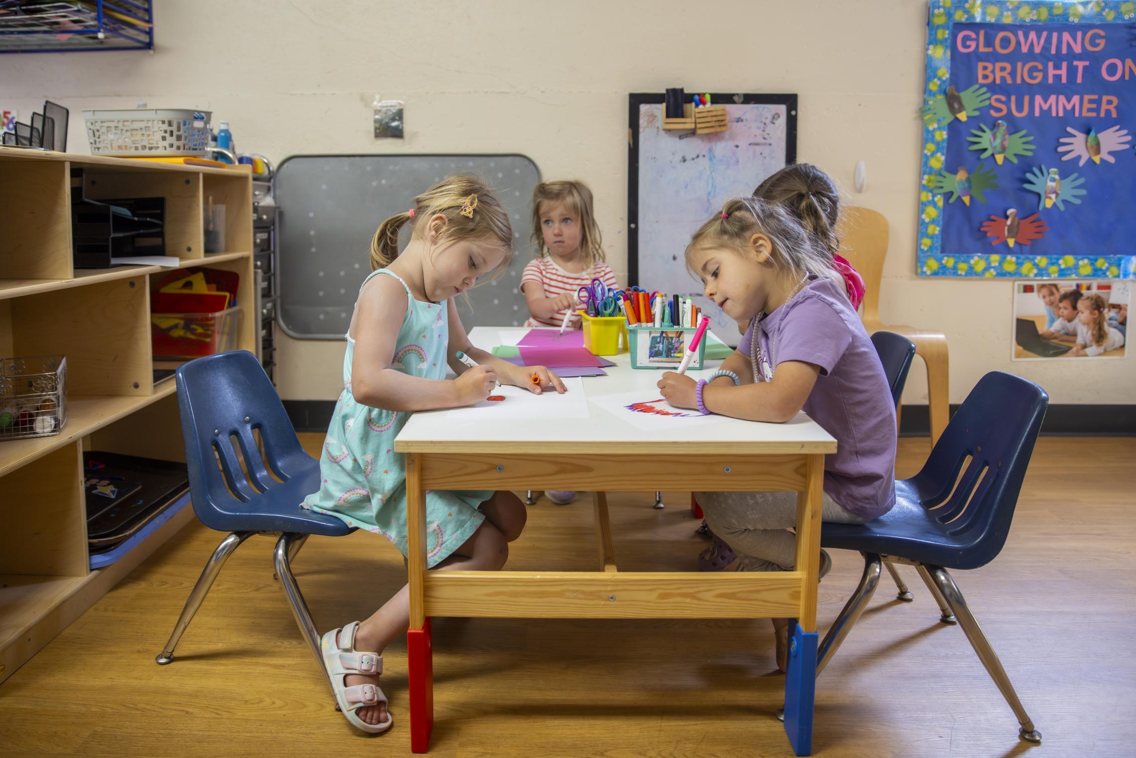 Children drawing at a table