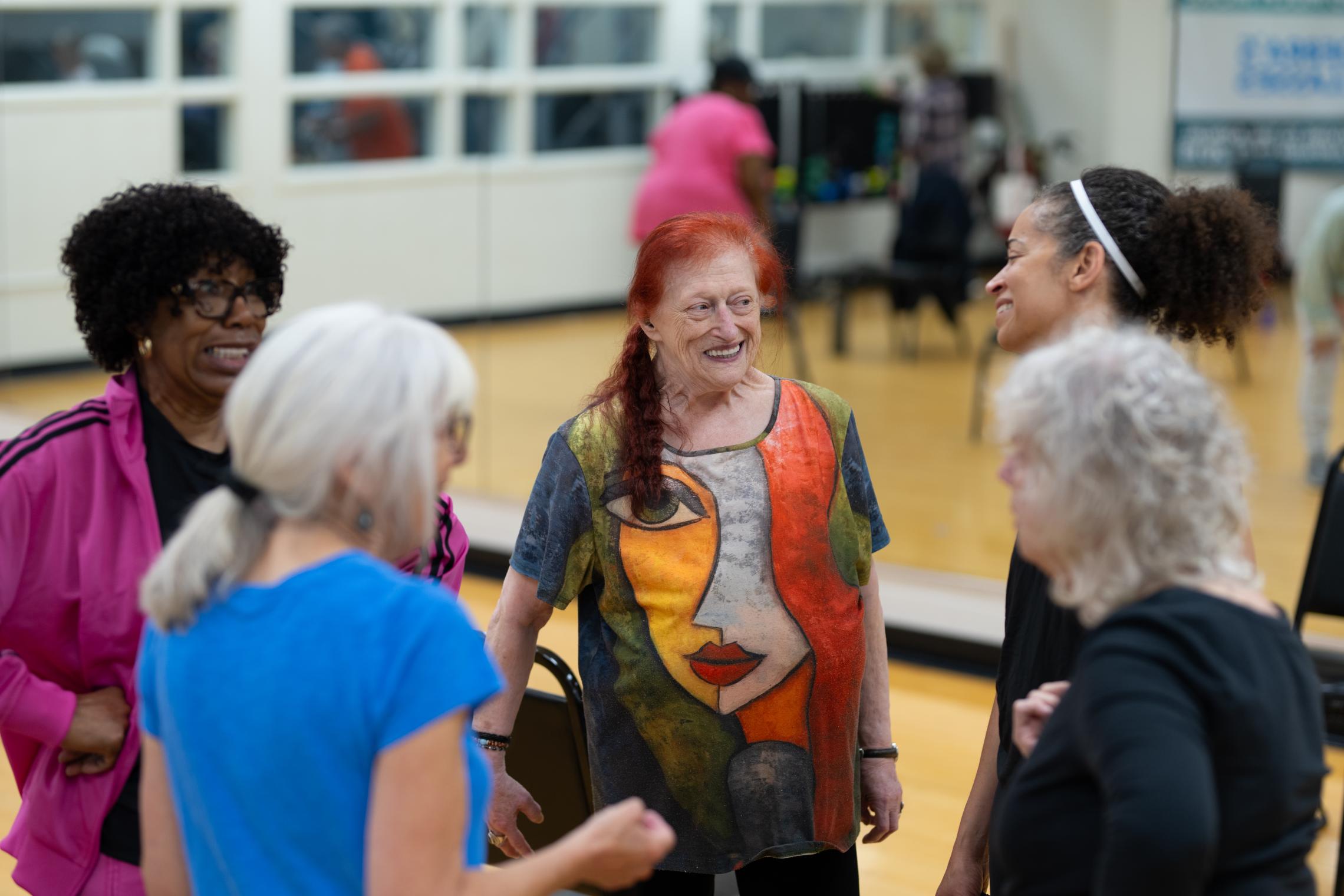 Silver Sneakers participants chat after class