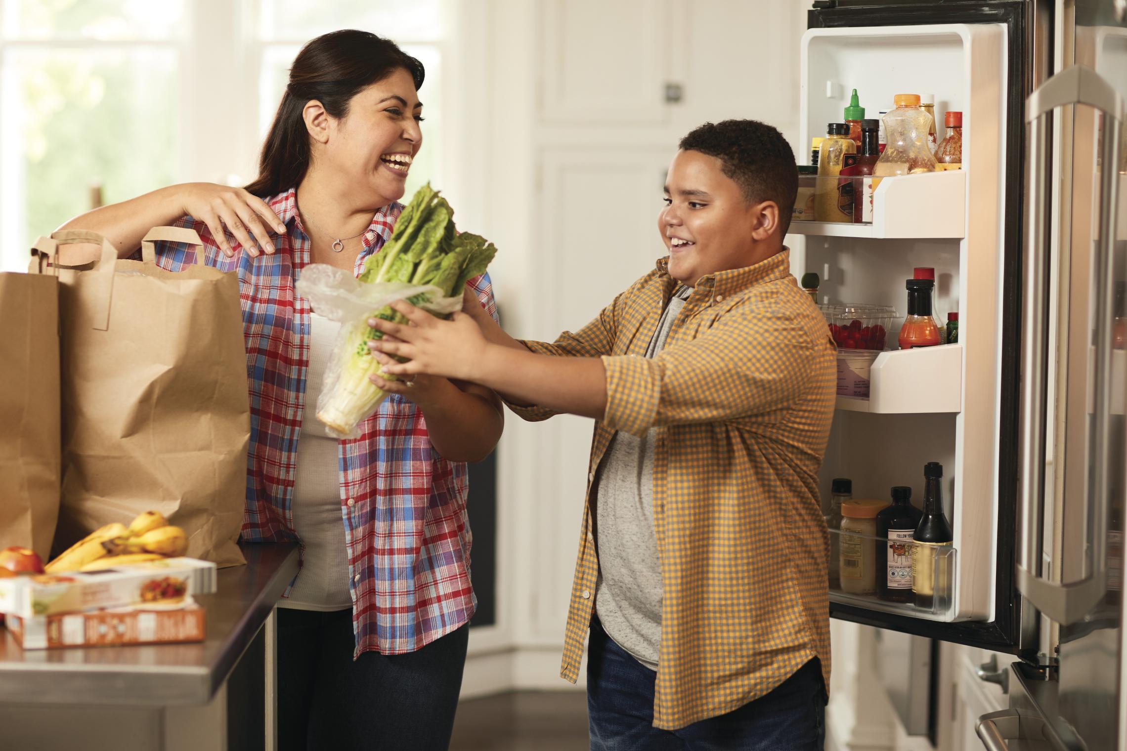 A mother and son unpacking groceries