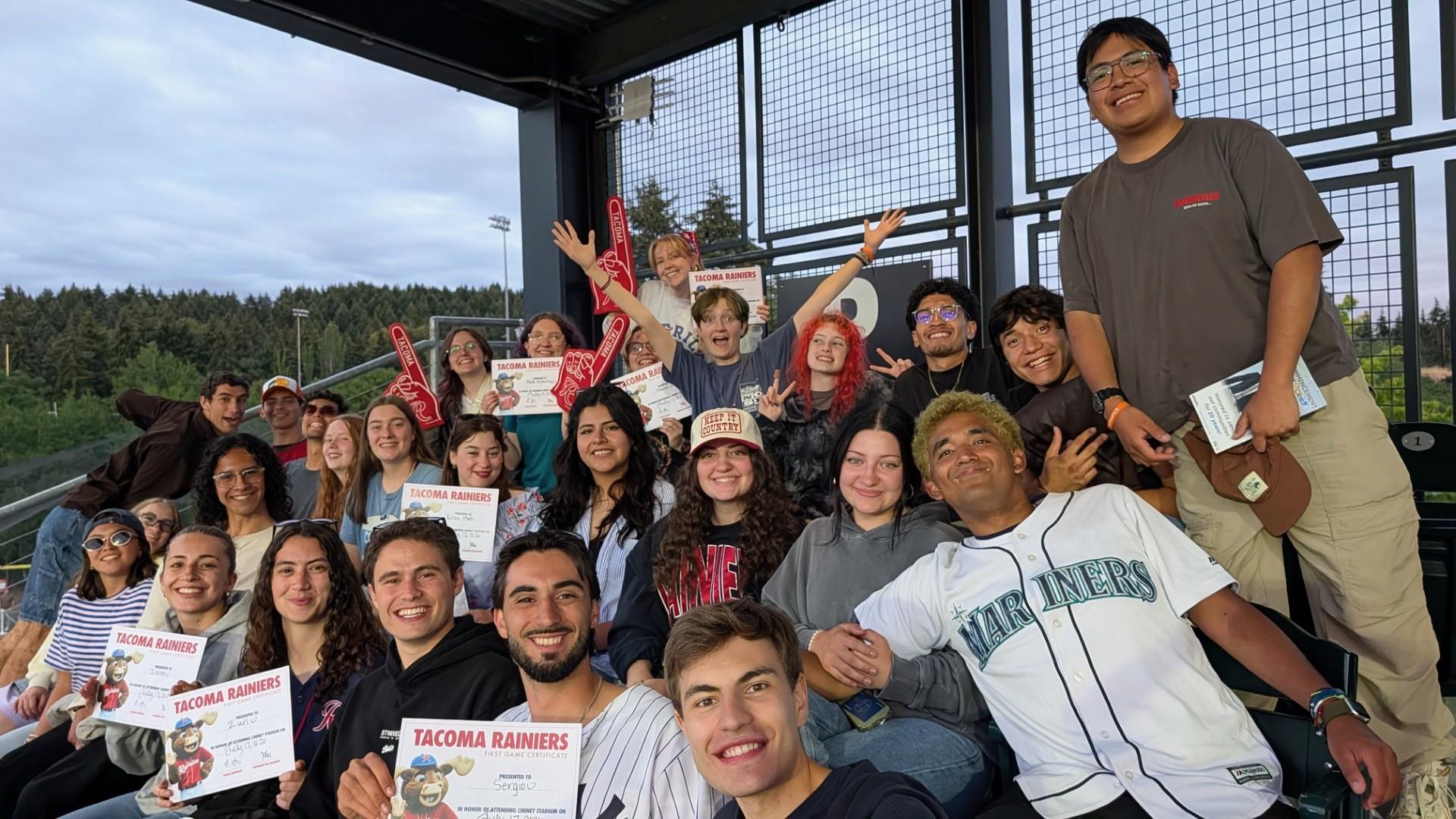 International and U.S. staff from YMCA Camp Seymour gather at a Tacoma Rainiers baseball game, celebrating cultural exchange, friendship, and community during the summer camp season.