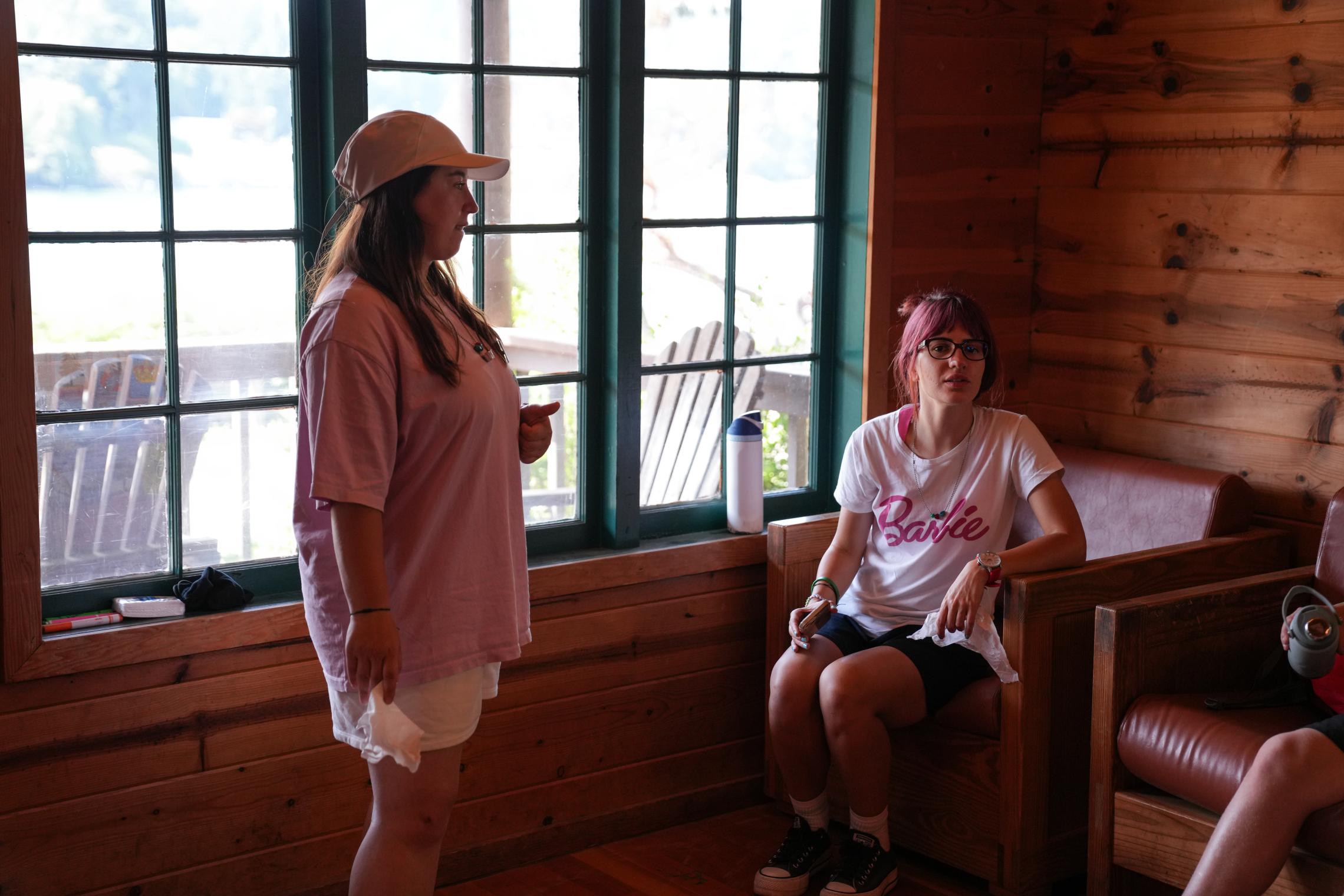 YMCA Kosovo counselors Erza and Riga lead a cultural activity inside a Camp Seymour cabin, sharing traditions and connecting with campers through the traditional Albanian handkerchief dance.