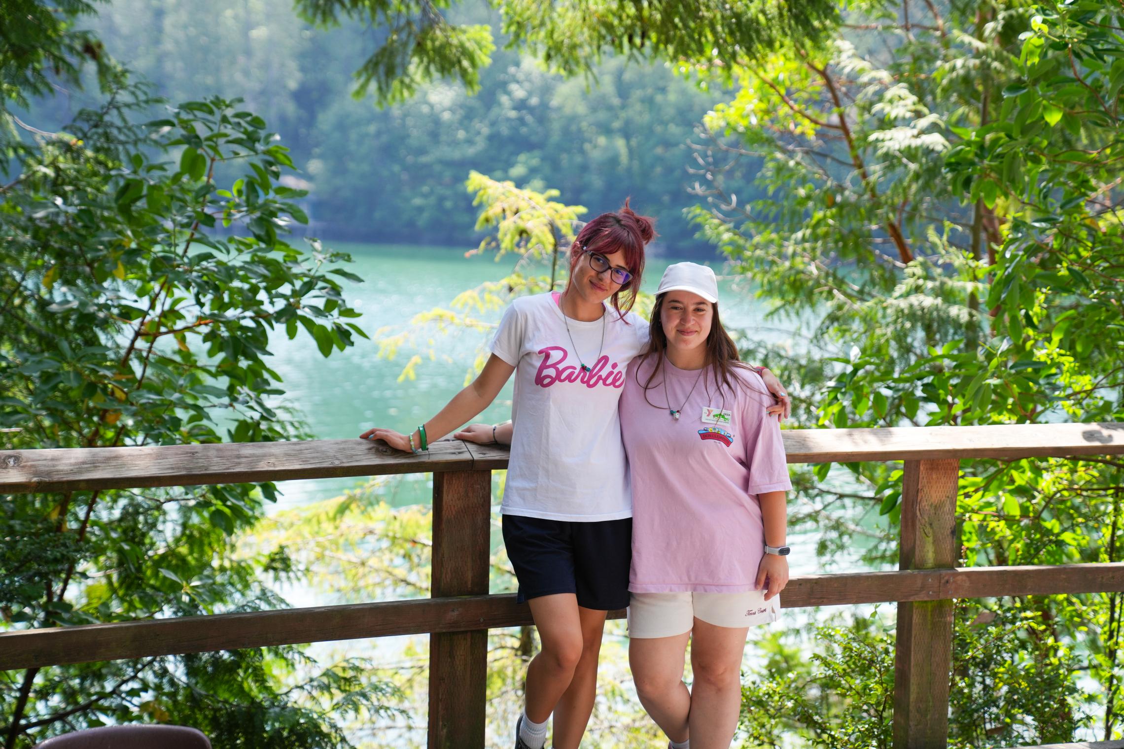 YMCA Kosovo counselors Erza and Riga stand together overlooking the waterfront at Camp Seymour, where they spent the summer learning overnight camp leadership and youth development practices.