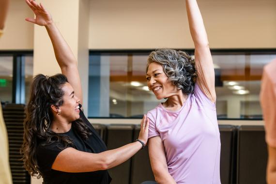 Active Older Adult Stretching In YMCA Group Exercise Class