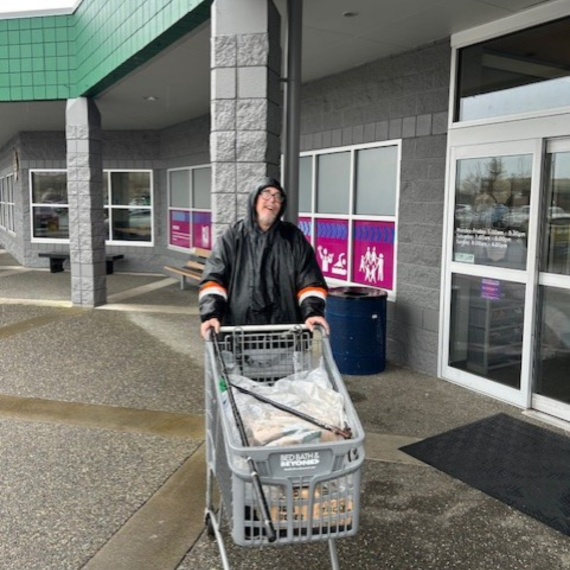 Teddy with donations in a shopping cart for the Little Free Pantry