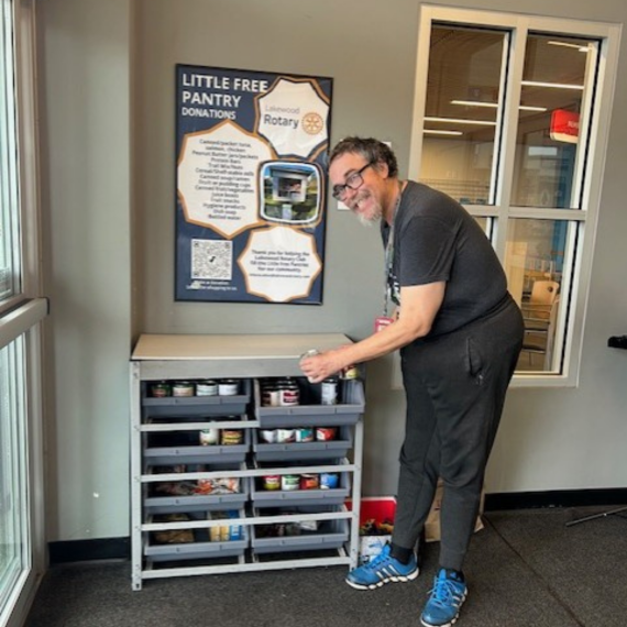 Teddy stocking the Little Free Pantry