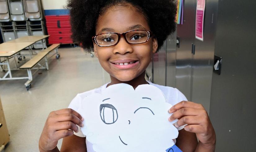 Girl Showing Off Art in YMCA Visual Arts Class