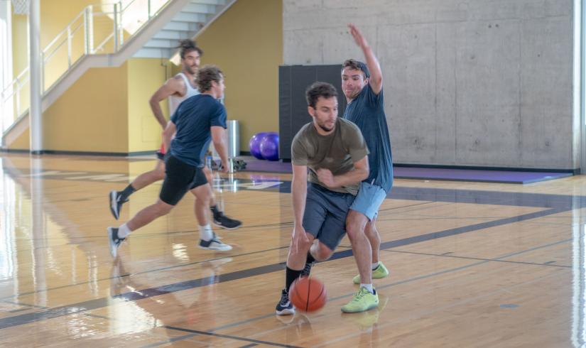 Group Playing Basketball At Their Local YMCA