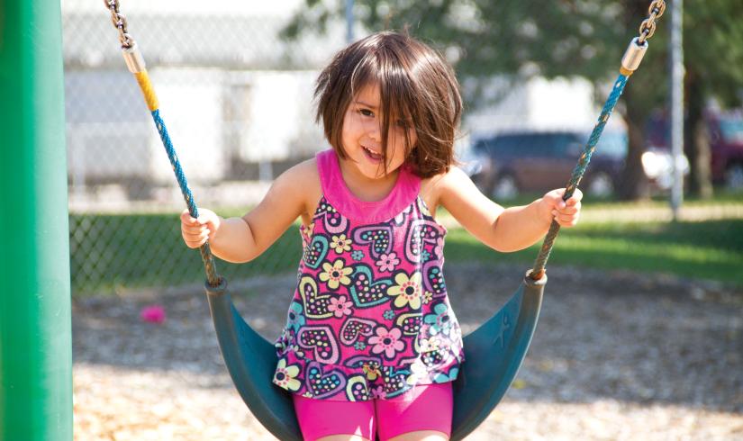 Smiling and Swinging At YMCA Child Care