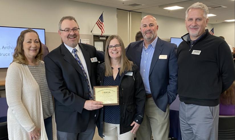 Karen Andersen, Scotty Jackson, Diane Jackson, Dan Gregory and John Hellwich stand together smiling as the YMCA of Pierce and Kitsap Counties accepts an award for its pandemic program -- Seymour Scholars-- which supported distance based learning for students.
