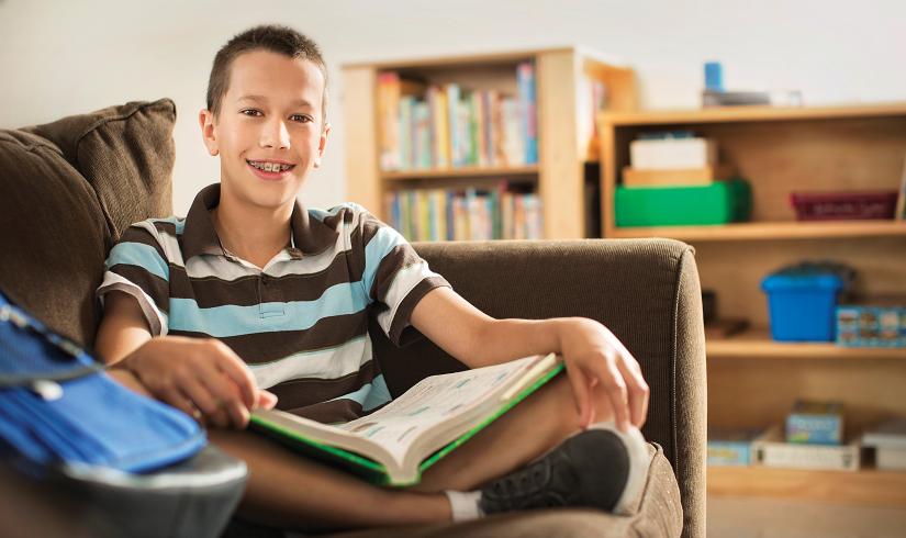 Teen reading on couch