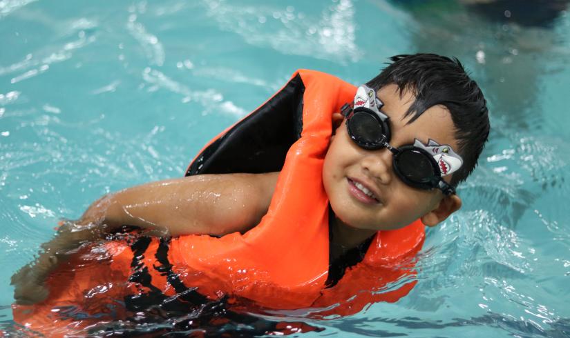 Youth in personal floatation device in our summer swimming program