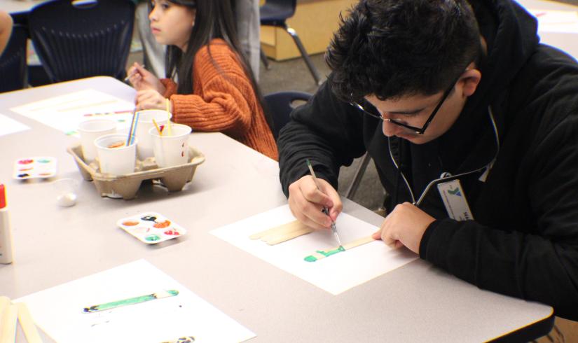 Site Leader Sean Chavez 18, working on an art project with the After School Care participants