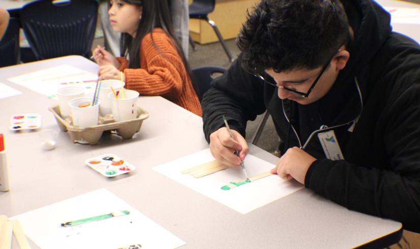 Site Leader Sean Chavez 18, working on an art project with the After School Care participants   