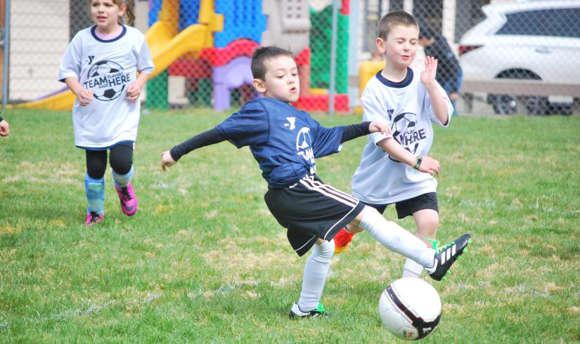 Youth soccer player making a kick