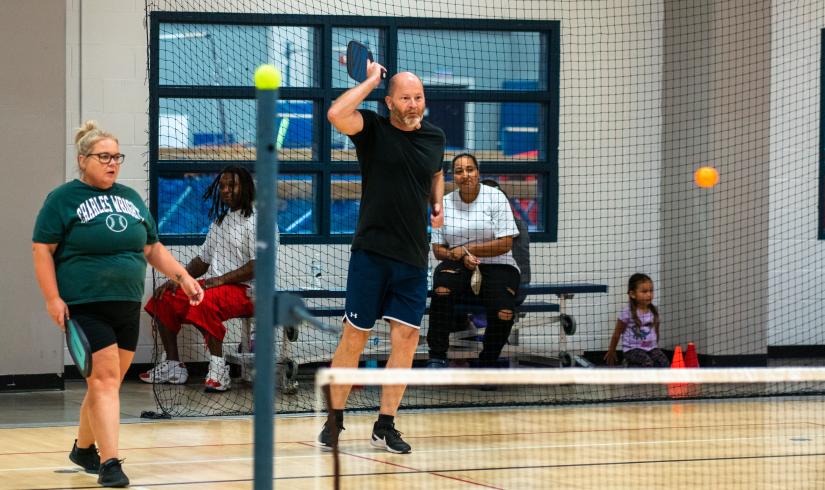 PIckleball players shoot the ball across the net at Tom Taylor Family YMCA.