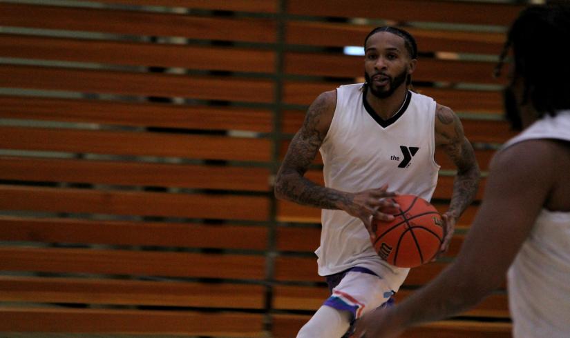 Adult basketball player drives the ball into the key