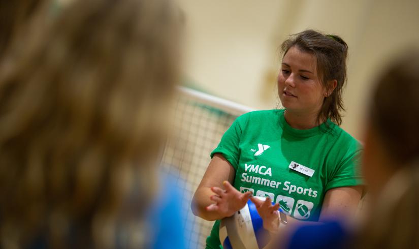 YMCA volleyball coach demonstrating good hand position