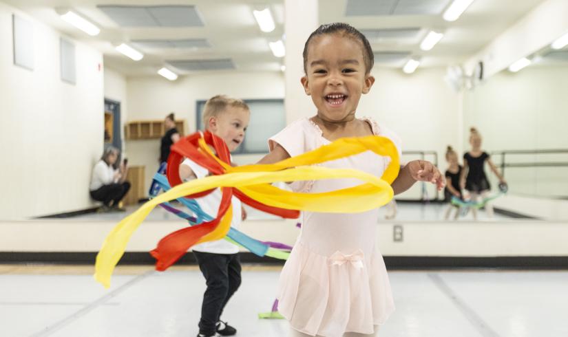 Toddler ballet students play with flow ribbons at the YMCA